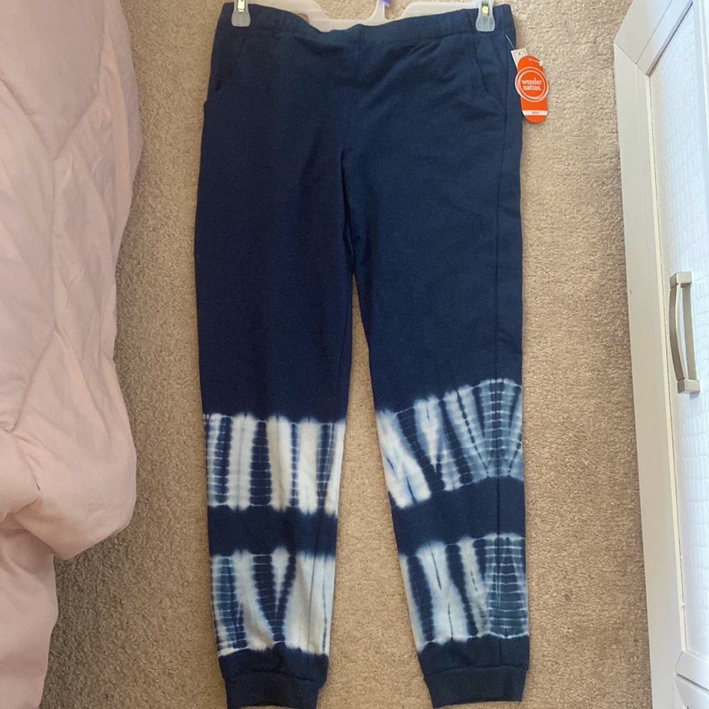 Navy blue sweatpants w/ white pattern on bottom. Has pockets.